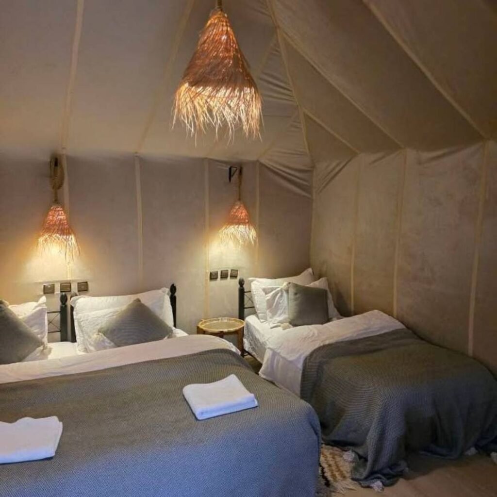 Cozy twin bed setup in a luxury desert camp on a 5 Days Tour from Marrakech to Fes.