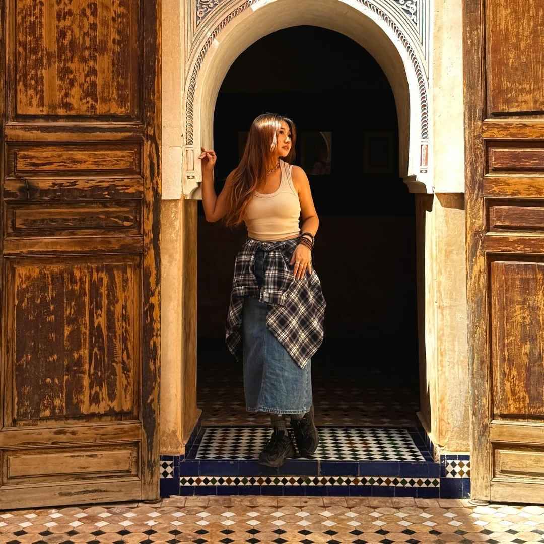 Female traveler exploring a historic Moroccan riad with Go Morocco Ogle, the Best Morocco Tours Agency.